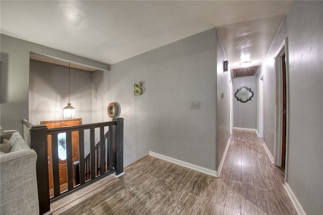 hall with hardwood / wood-style floors