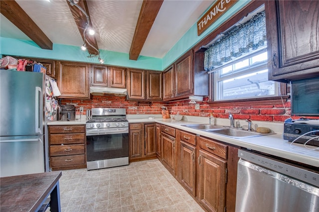 kitchen featuring stainless steel appliances, beamed ceiling, sink, and decorative backsplash