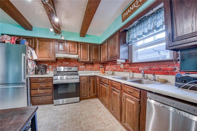 2759 Brodhead Rd, Aliquippa, PA 15001 - kitchen with appliances with stainless steel finishes, beamed ceiling, under cabinet range hood, brown cabinets, and backsplash