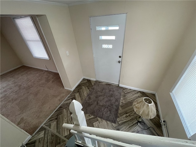 foyer featuring parquet floors and crown molding