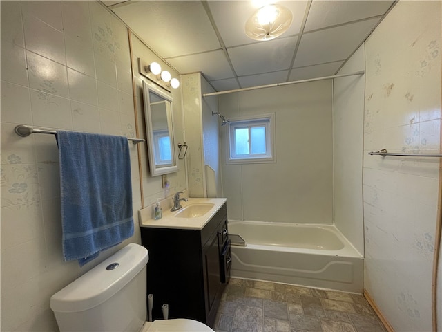 full bathroom with vanity, a paneled ceiling, toilet, and  shower combination