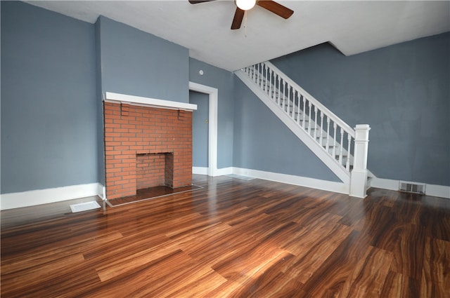 unfurnished living room with hardwood / wood-style floors, a fireplace, and ceiling fan