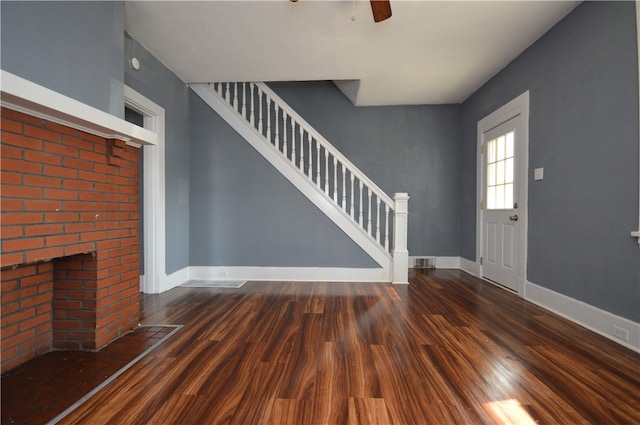 foyer with dark hardwood / wood-style floors and a fireplace