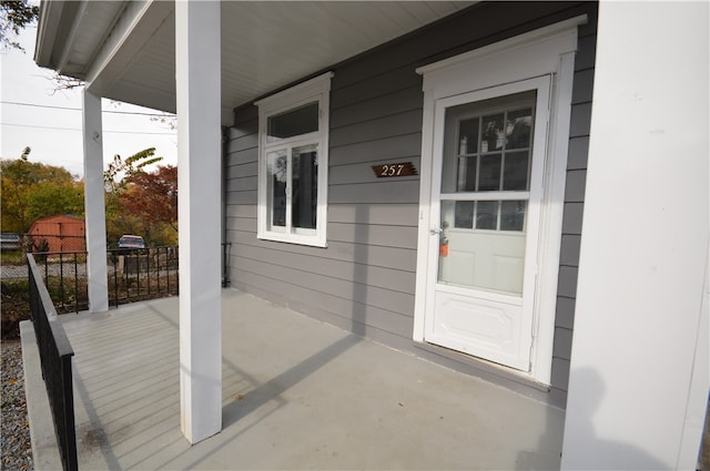 view of exterior entry with a porch