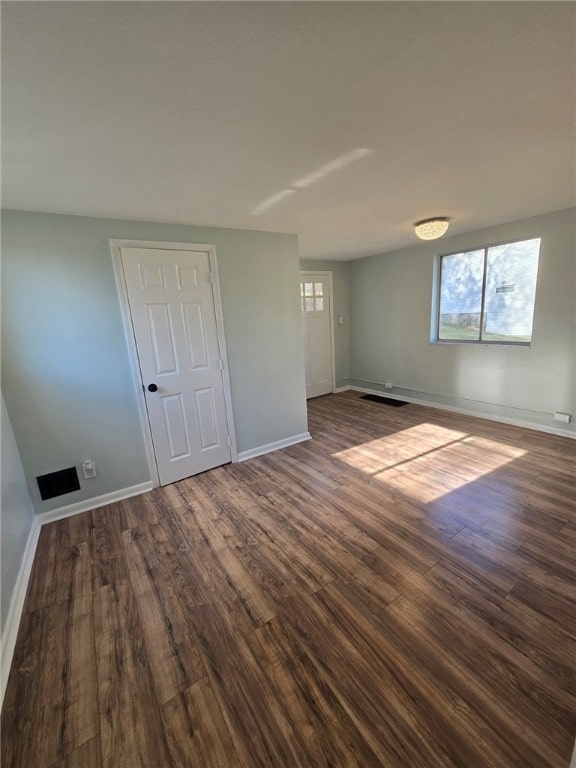 spare room featuring dark hardwood / wood-style floors