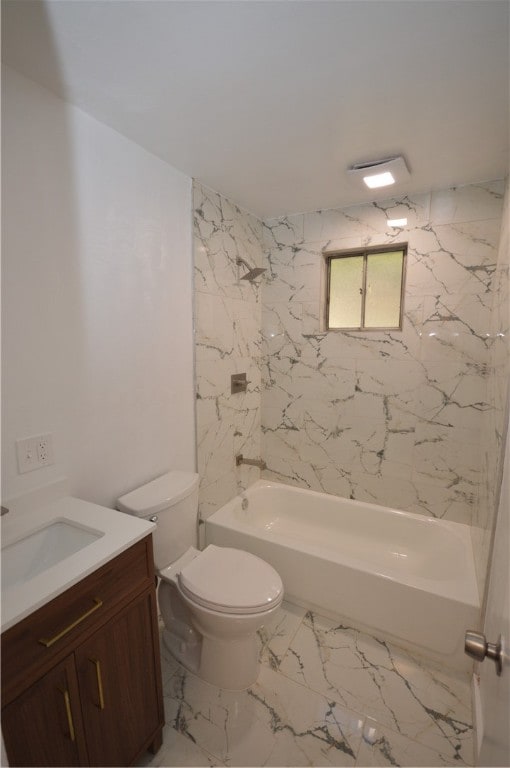 full bathroom featuring vanity, tiled shower / bath, and toilet