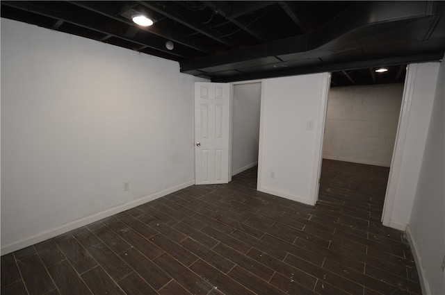 basement with dark wood-type flooring