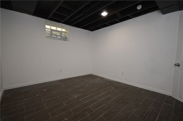 basement with dark hardwood / wood-style floors