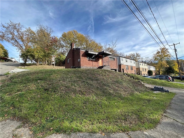 view of property exterior with a lawn