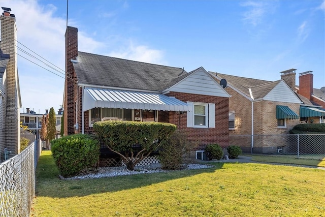 rear view of house with a yard