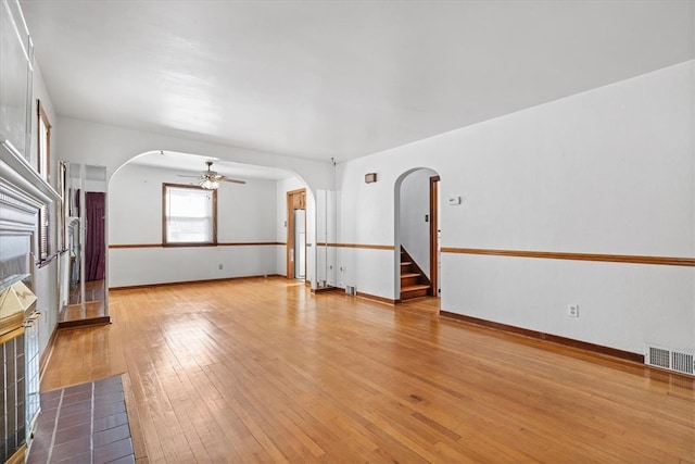 unfurnished living room featuring light wood-type flooring and ceiling fan