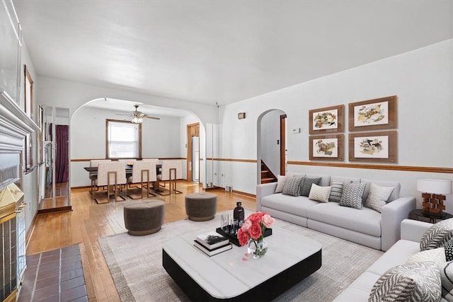 living room featuring light wood-type flooring and ceiling fan