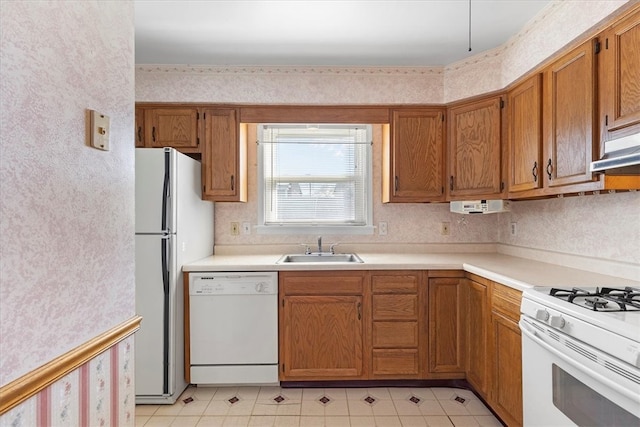 kitchen featuring white appliances and sink