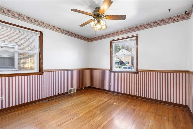 spare room featuring light hardwood / wood-style flooring and ceiling fan