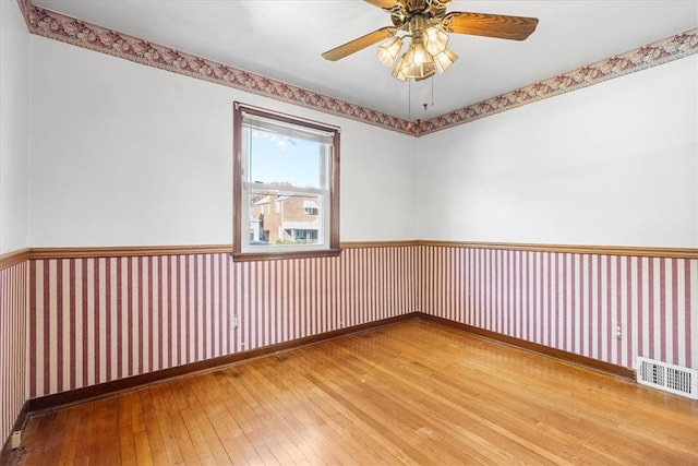 spare room featuring hardwood / wood-style flooring and ceiling fan