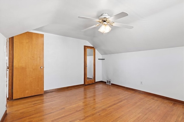 bonus room with ceiling fan, light hardwood / wood-style flooring, and vaulted ceiling