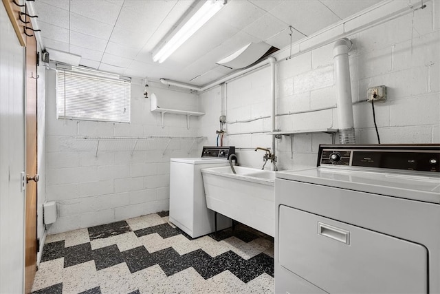 clothes washing area with sink and washer and dryer