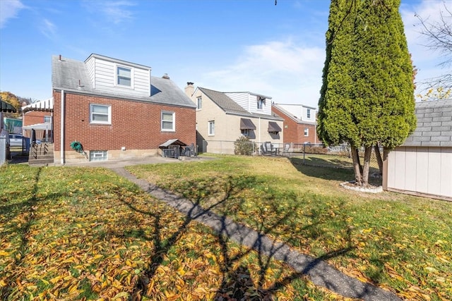 rear view of property with a lawn