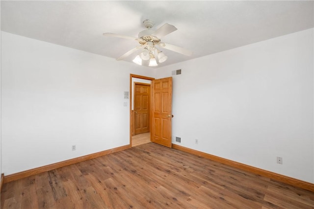 spare room featuring ceiling fan and hardwood / wood-style flooring