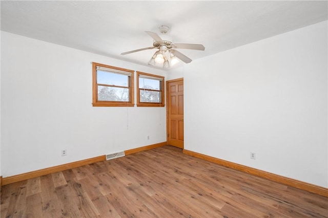 unfurnished room with ceiling fan and light hardwood / wood-style flooring