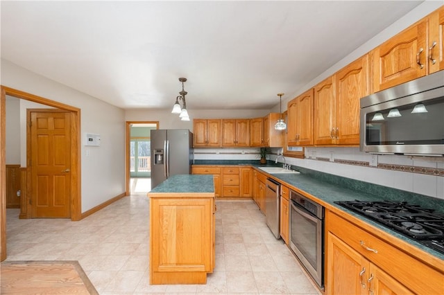 kitchen featuring hanging light fixtures, decorative backsplash, appliances with stainless steel finishes, and a center island