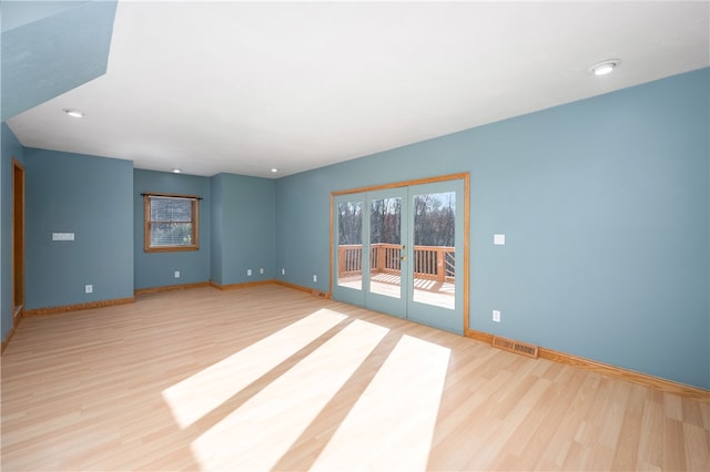 spare room with light hardwood / wood-style flooring