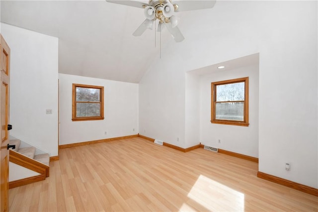 unfurnished living room with ceiling fan, lofted ceiling, and light hardwood / wood-style flooring