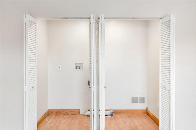 washroom featuring wood-type flooring and hookup for a washing machine