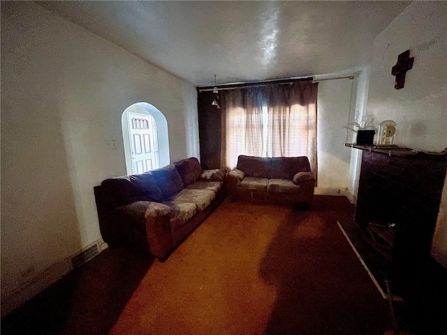 carpeted living room with vaulted ceiling