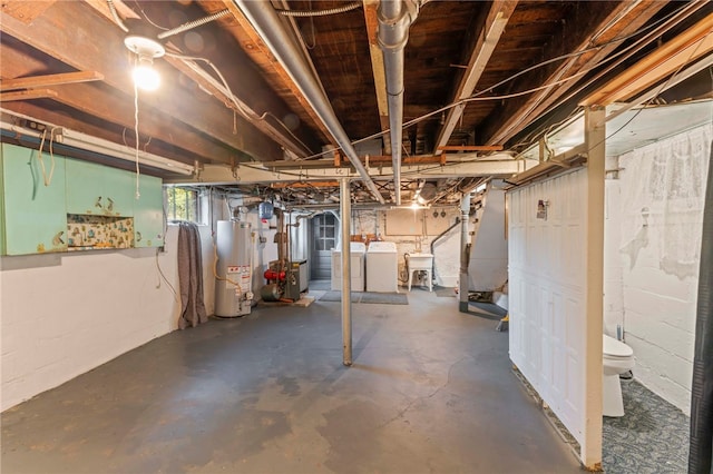 basement with water heater, sink, and washing machine and clothes dryer