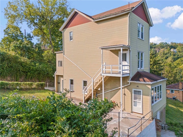 back of property with a patio