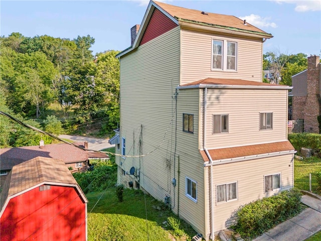 view of home's exterior with a storage unit