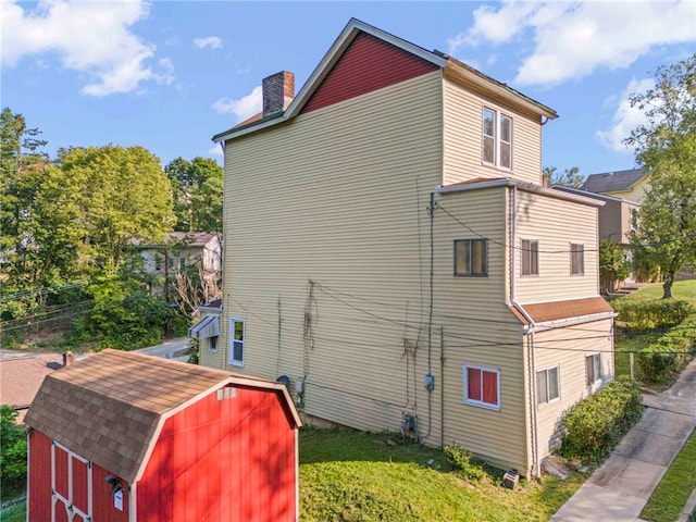 view of side of property featuring a storage unit