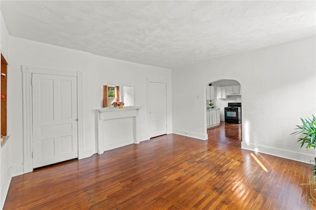 spare room with dark wood-type flooring and a textured ceiling