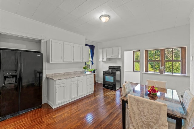 kitchen featuring black appliances, dark wood-type flooring, and white cabinets