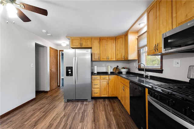 kitchen featuring stainless steel appliances, ceiling fan, sink, and dark hardwood / wood-style flooring