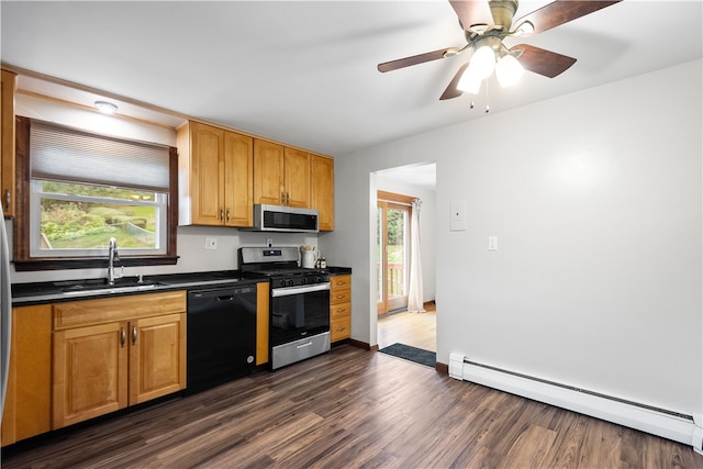 kitchen featuring a wealth of natural light, appliances with stainless steel finishes, dark hardwood / wood-style floors, and a baseboard radiator