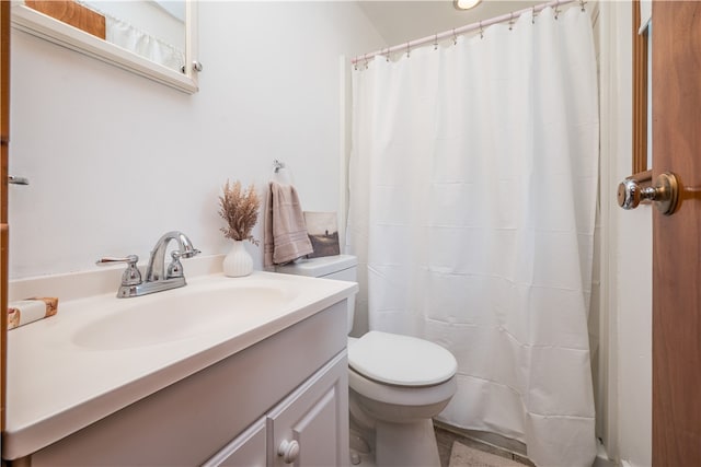 bathroom with toilet and vanity