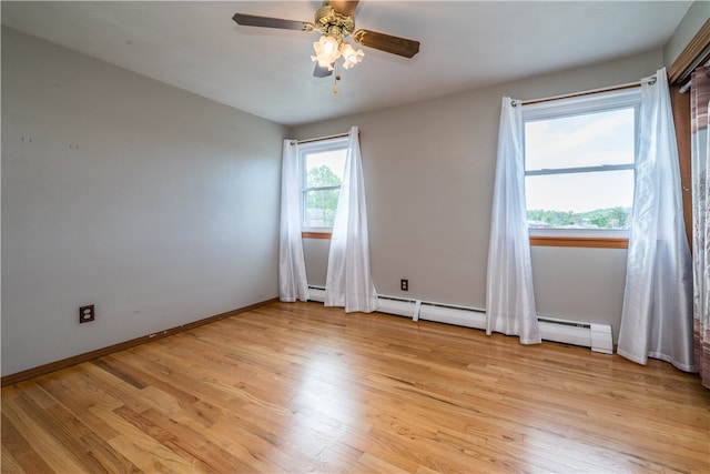 spare room featuring light wood-type flooring and ceiling fan