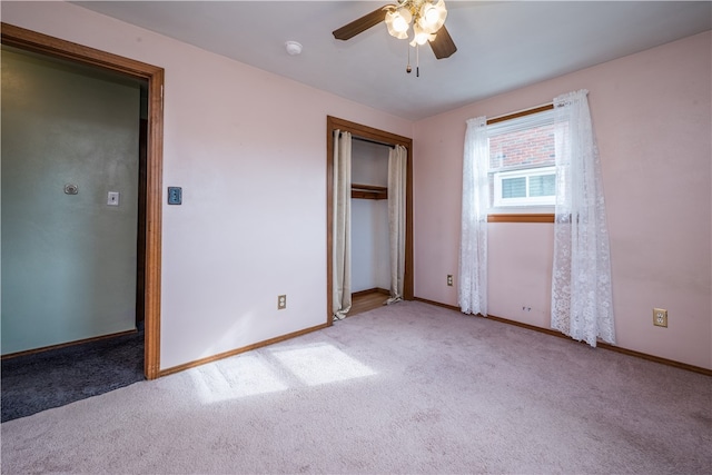 unfurnished bedroom featuring ceiling fan, light carpet, and a closet