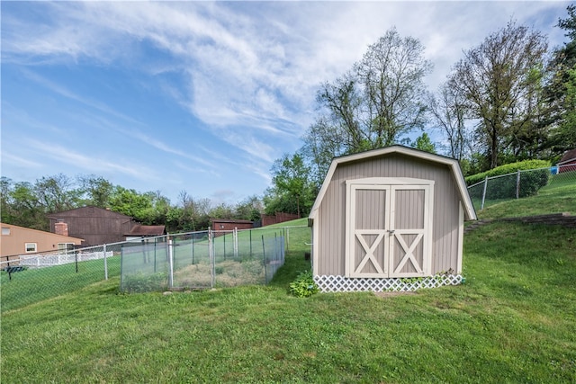 view of outdoor structure featuring a lawn