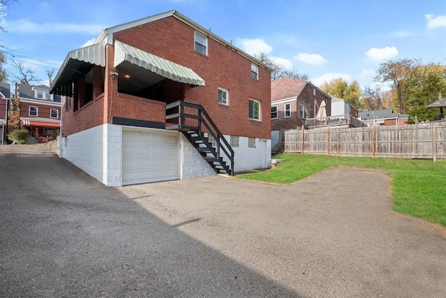 rear view of property featuring a garage