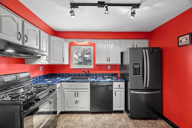 kitchen featuring black appliances, tile countertops, white cabinetry, and rail lighting