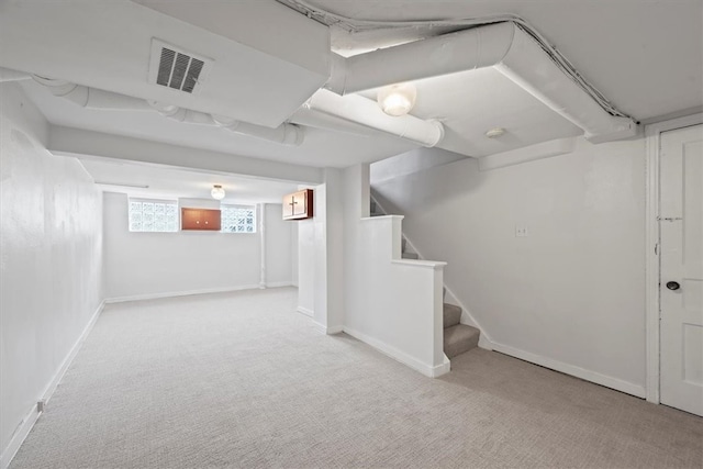 basement featuring light carpet