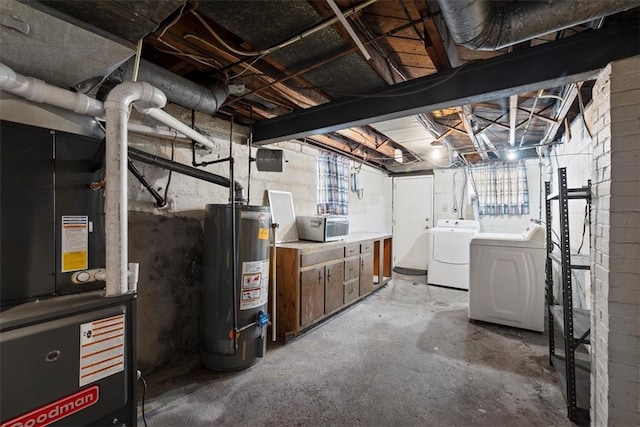 basement with washing machine and dryer, heating unit, and gas water heater