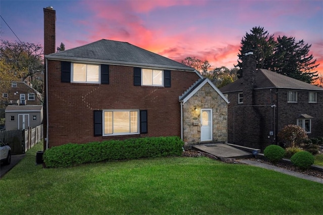 front facade with a patio and a yard