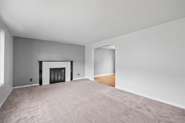 unfurnished living room with light colored carpet