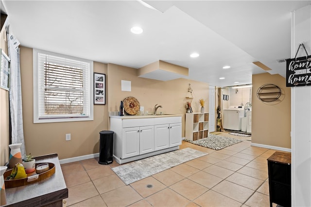 welcome area with separate washer and dryer and sink