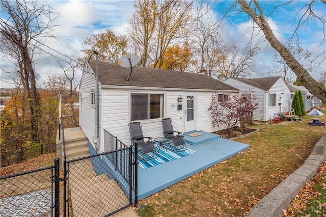 rear view of property featuring a yard