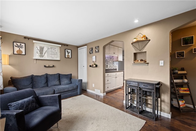 living room with dark hardwood / wood-style flooring